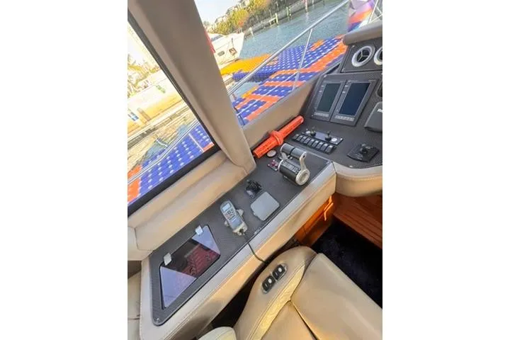  Yacht Photos Pics Interior view of 2014 Azimut 70 yacht cockpit with navigation controls and scenic waterway.