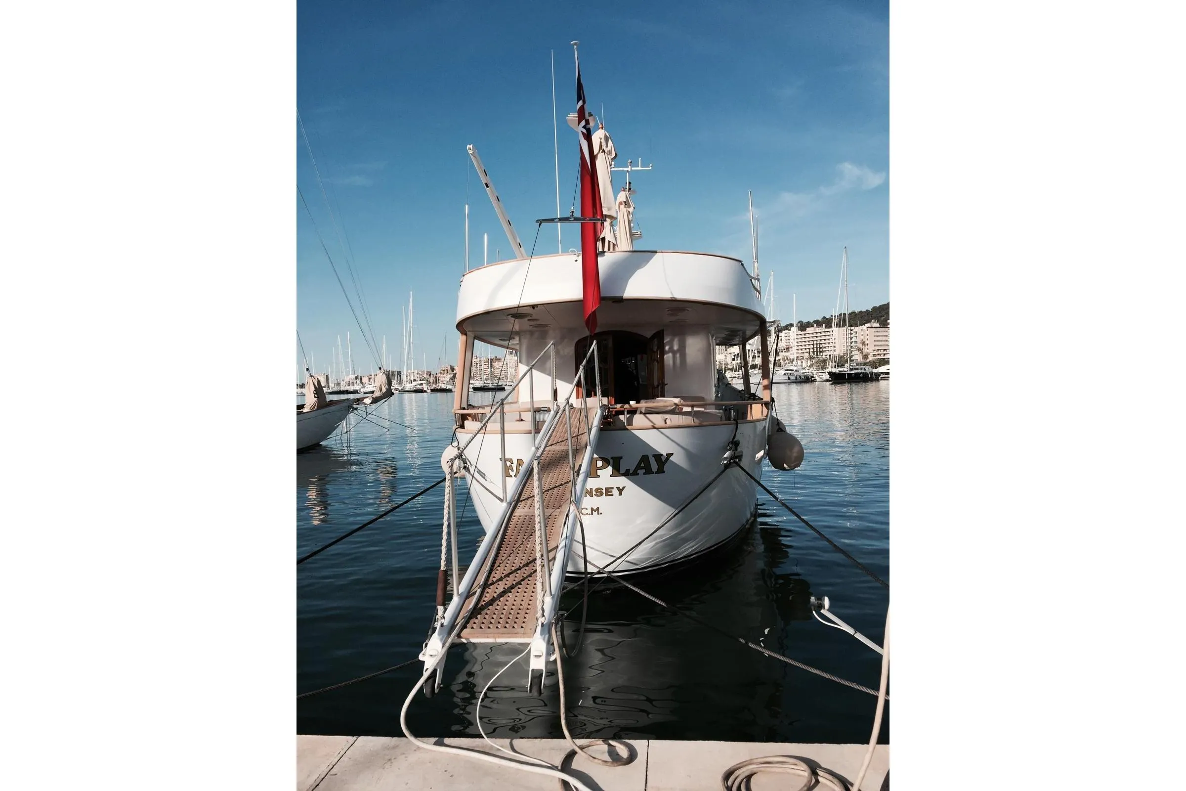 Luxury Codecasa 27m yacht from 1977 docked in a serene marina.