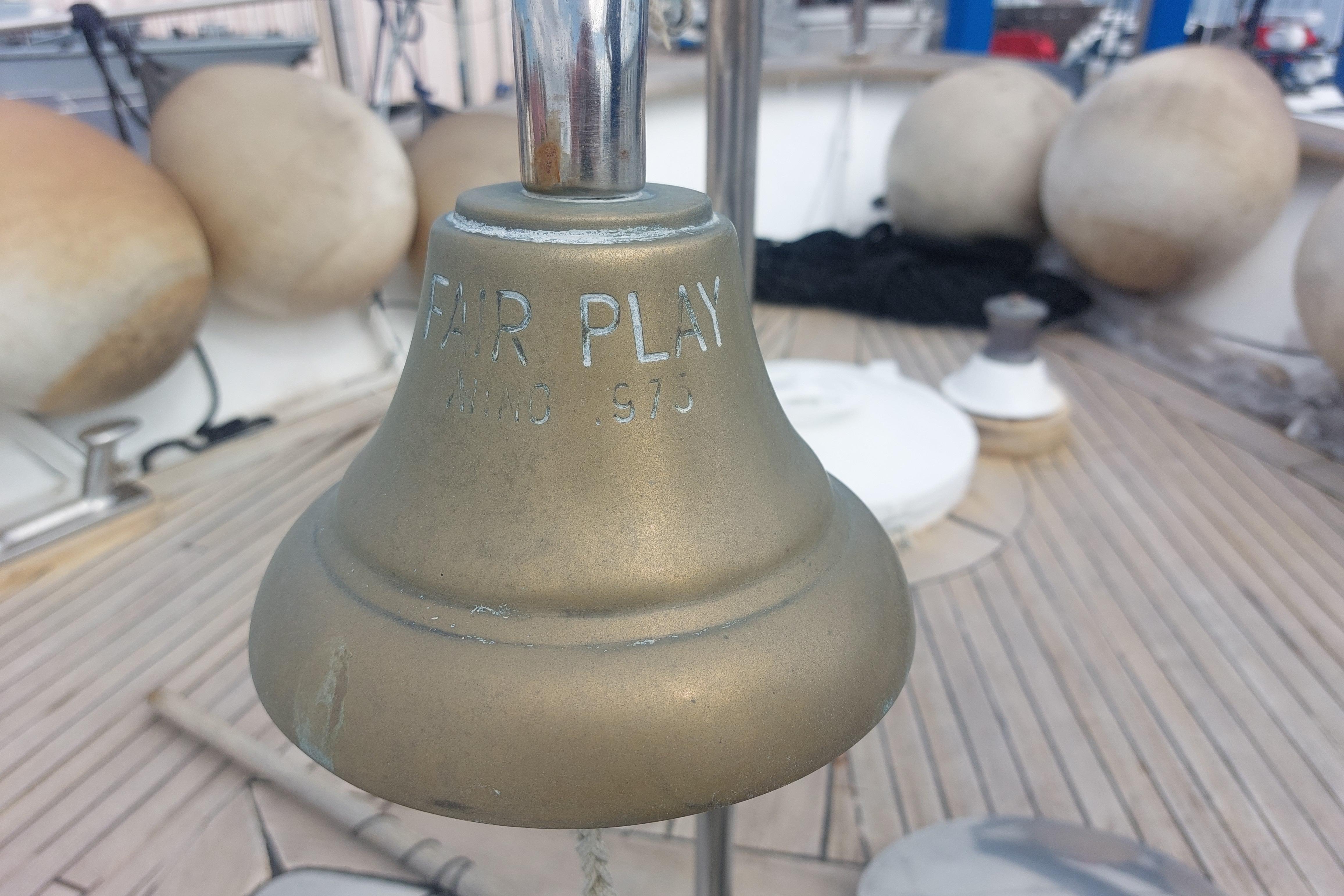 Bronze ship bell on 1977 Codecasa 27m yacht deck, engraved "FAIR PLAY".