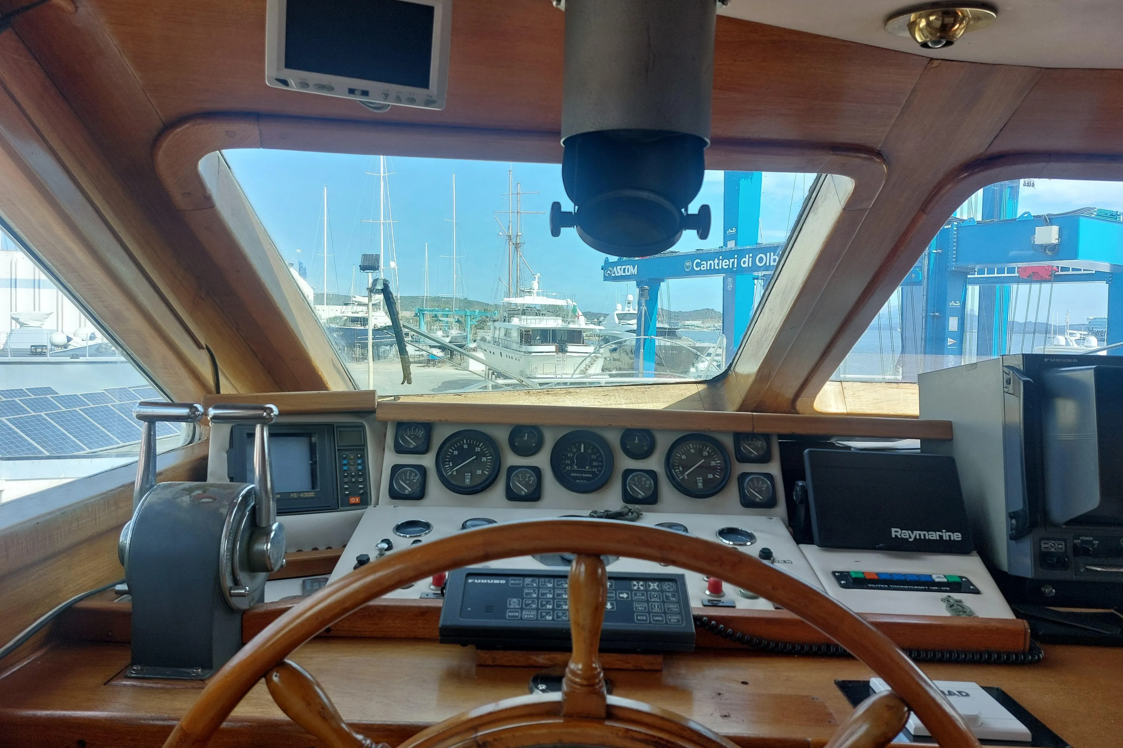 Interior view of a 1977 Codecasa 27m yacht cockpit with navigation instruments.