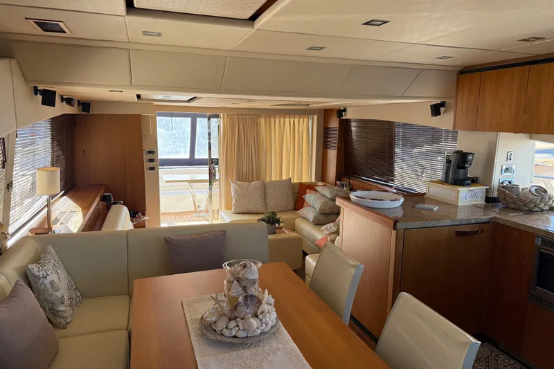 Thomas Yacht Photos Pics Luxurious interior of 2012 Sunseeker Manhattan 63 yacht with elegant dining and lounge area.