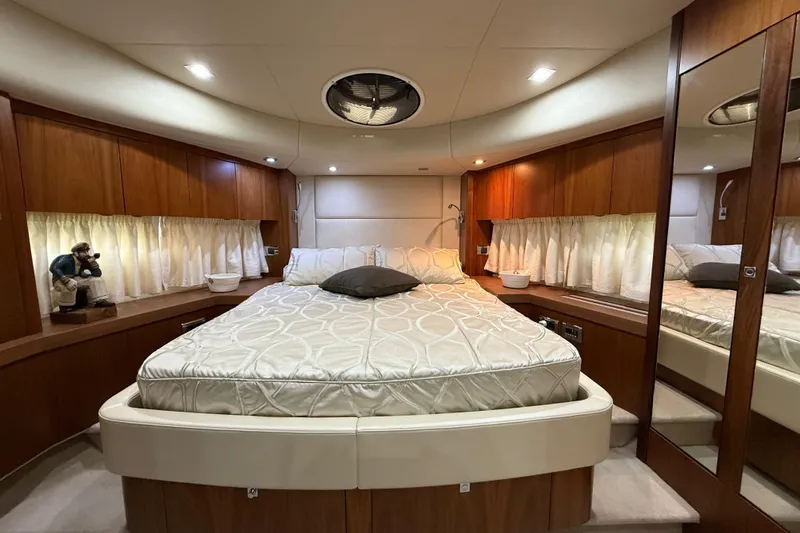 Thomas Yacht Photos Pics Luxurious bedroom interior of 2012 Sunseeker Manhattan 63 yacht with elegant wood finishes.