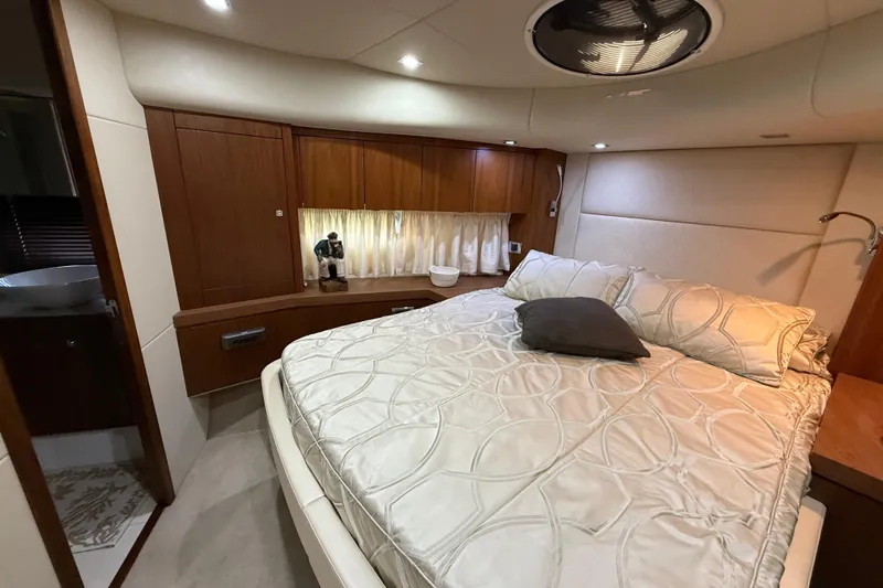Thomas Yacht Photos Pics Luxurious bedroom interior of 2012 Sunseeker Manhattan 63 yacht with elegant bedding and wood accents.