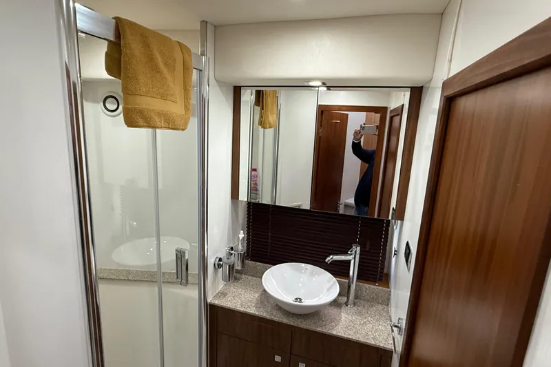 Thomas Yacht Photos Pics Luxurious bathroom in 2012 Sunseeker Manhattan 63 yacht with modern fixtures and elegant design.