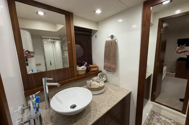 Thomas Yacht Photos Pics Luxurious bathroom interior of 2012 Sunseeker Manhattan 63 yacht, featuring modern sink and elegant decor.