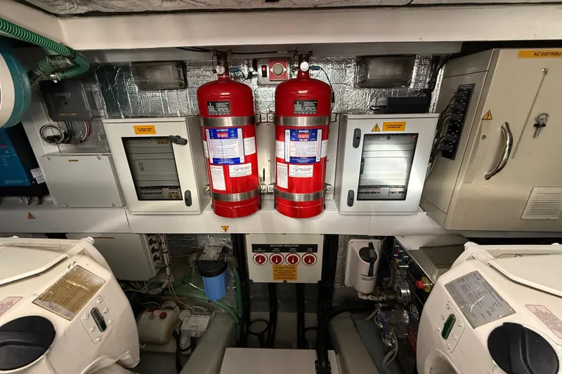 Thomas Yacht Photos Pics Engine room of 2012 Sunseeker Manhattan 63 yacht with fire extinguishers and control panels.