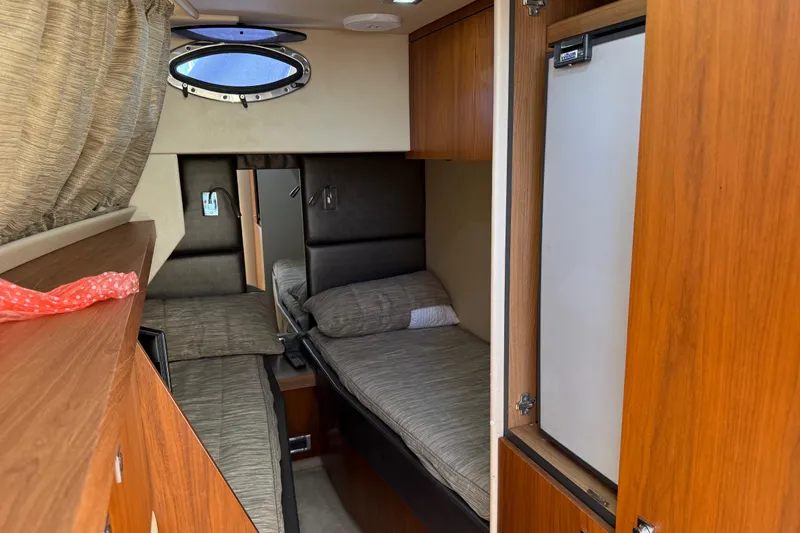 Thomas Yacht Photos Pics Interior cabin of 2012 Sunseeker Manhattan 63 yacht with twin beds and wooden cabinetry.