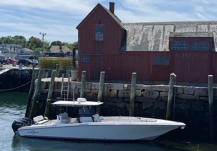  Yacht Photos Pics Fountain 38 Tournament Edition 2021 boat docked by red building.