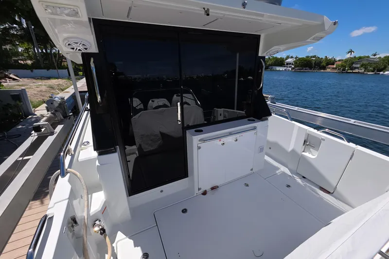  Yacht Photos Pics 2024 Wellcraft 355 Commuter boat deck with sleek design and waterfront view.