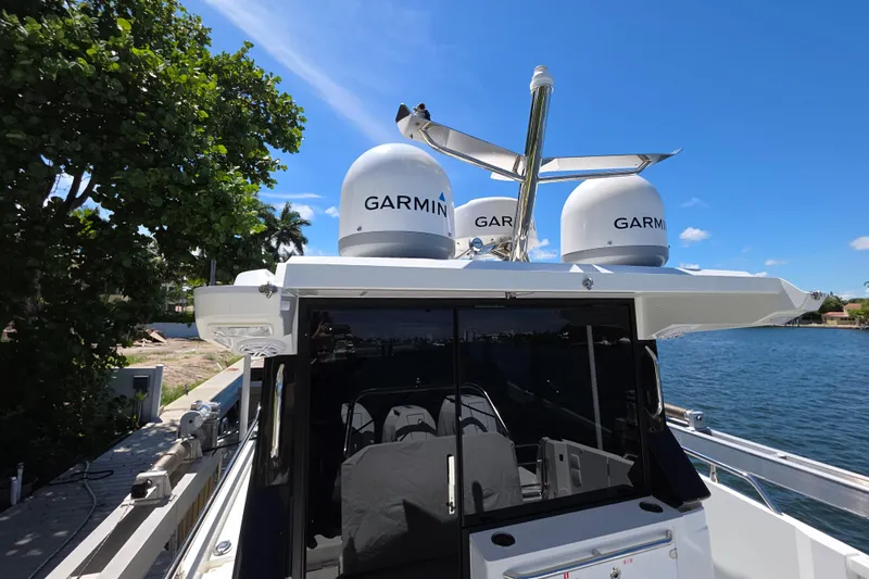  Yacht Photos Pics 2024 Wellcraft 355 Commuter boat with Garmin equipment, docked by a scenic waterfront.