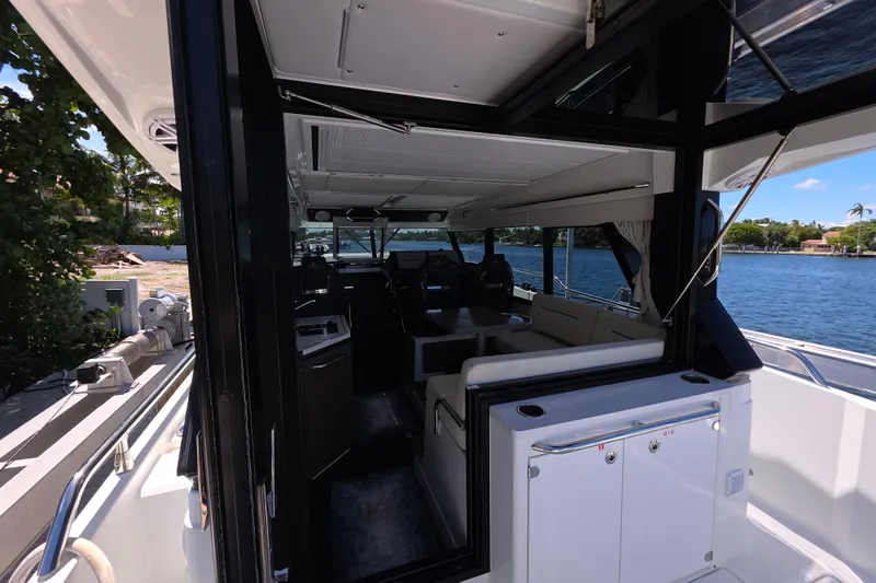  Yacht Photos Pics 2024 Wellcraft 355 Commuter interior with seating, overlooking serene waterfront.