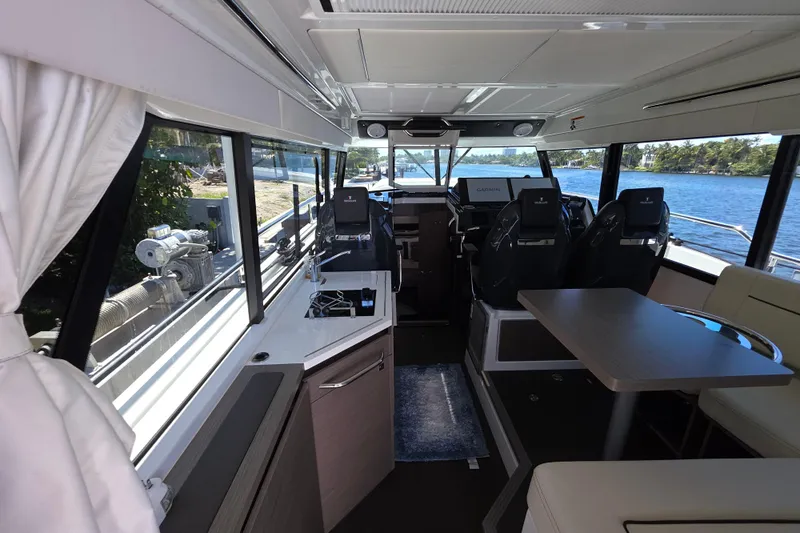  Yacht Photos Pics Interior of 2024 Wellcraft 355 Commuter boat with modern seating and navigation equipment.