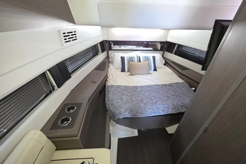  Yacht Photos Pics Luxurious cabin interior of 2024 Wellcraft 355 Commuter with cozy bed and modern design.