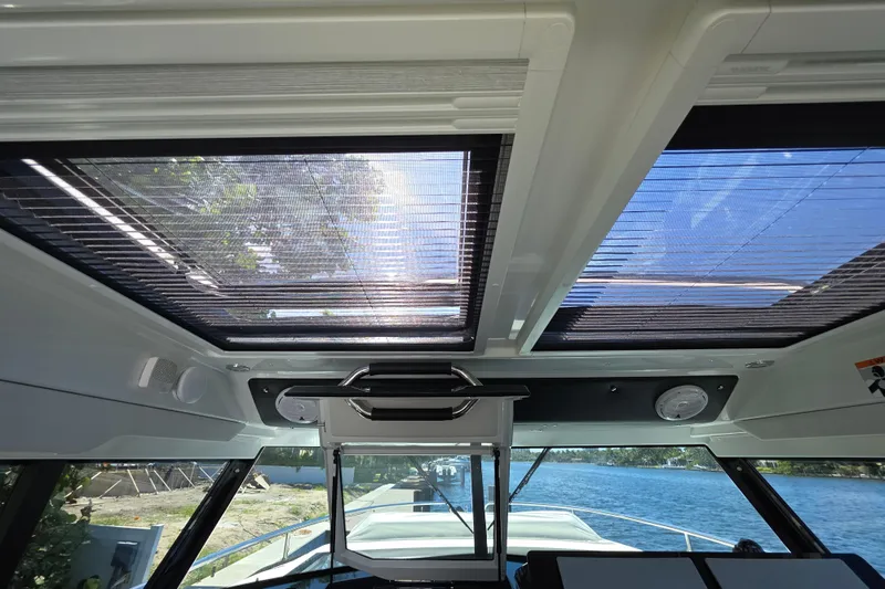  Yacht Photos Pics Interior view of 2024 Wellcraft 355 Commuter boat with sunroof and water scenery.