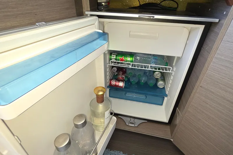  Yacht Photos Pics Mini fridge stocked with drinks inside a 2024 Wellcraft 355 Commuter boat.