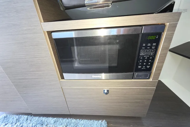  Yacht Photos Pics 2024 Wellcraft 355 Commuter interior featuring a built-in Danby microwave.