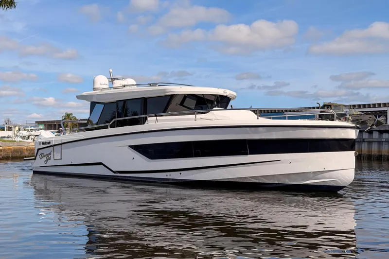  Yacht Photos Pics 2024 Wellcraft 355 Commuter boat on water, sleek design, sunny day, marina background.