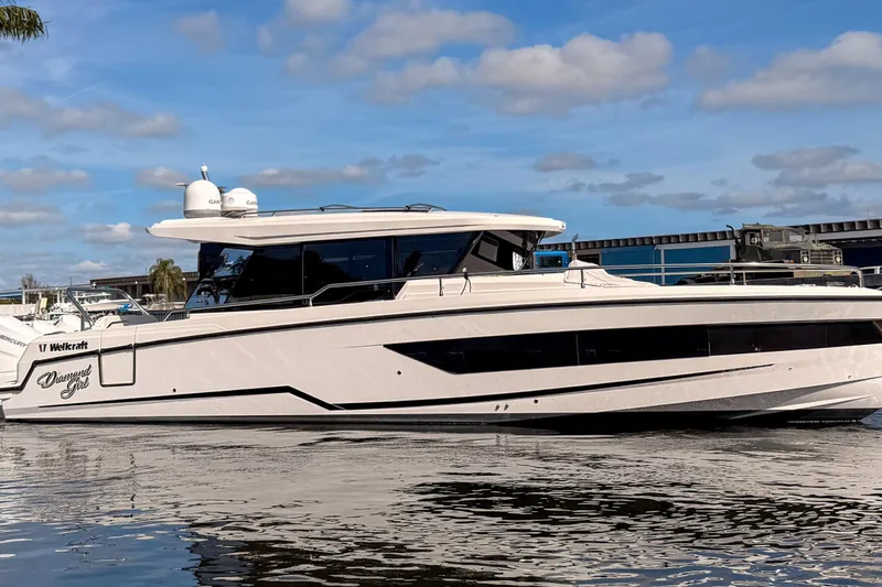  Yacht Photos Pics 2024 Wellcraft 355 Commuter boat on water under blue sky.