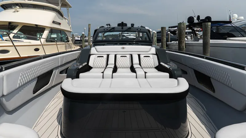  Yacht Photos Pics Luxury 2025 Cigarette 52 Thunder yacht interior with plush seating at a marina.