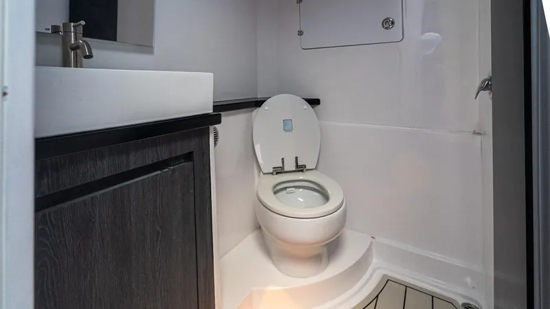  Yacht Photos Pics Modern bathroom in 2025 Cigarette 52 Thunder boat, featuring sleek sink and toilet design.