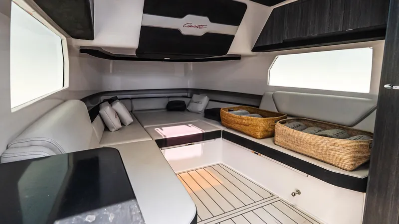  Yacht Photos Pics Interior of 2025 Cigarette 52 Thunder boat, featuring modern seating and storage baskets.