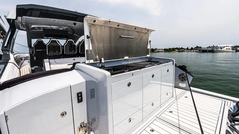  Yacht Photos Pics 2025 Cigarette 52 Thunder yacht with open deck storage, docked by the water.