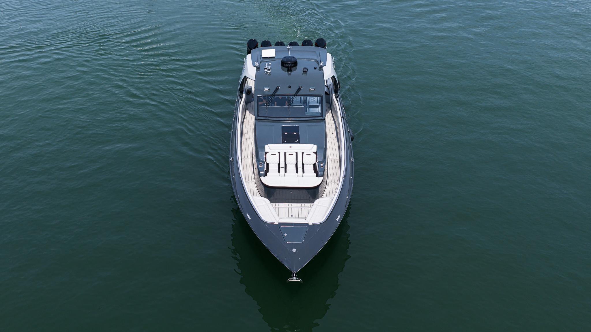 2025 Cigarette 52 Thunder boat on calm water, aerial view.