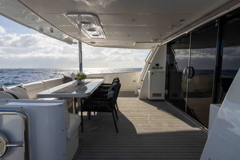 Aleniel Yacht Photos Pics Luxurious 2005 Johnson 87' Motor Yacht deck with ocean view and elegant dining area.