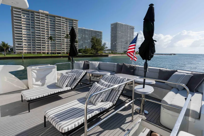 Aleniel Yacht Photos Pics Luxurious 2005 Johnson 87' Motor Yacht deck with sun loungers and ocean view.