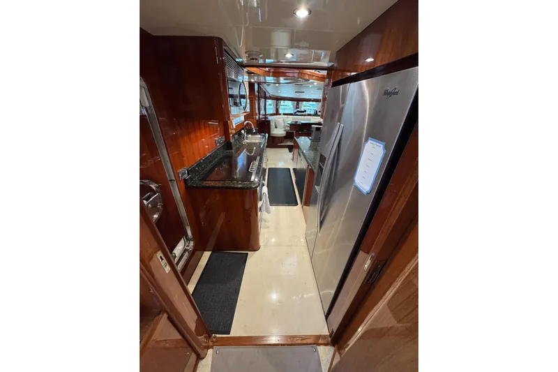 Aleniel Yacht Photos Pics Luxurious kitchen interior of 2005 Johnson 87' Motor Yacht with modern appliances and wood finishes.