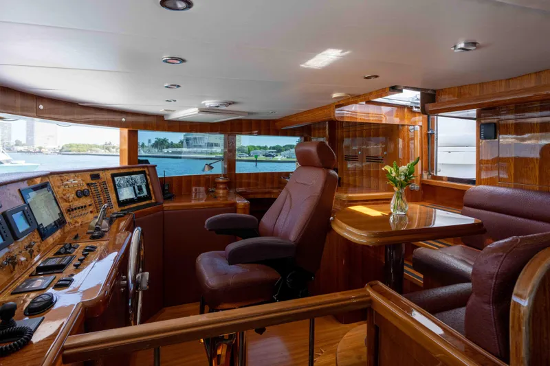 Aleniel Yacht Photos Pics Luxurious interior of a 2005 Johnson 87' Motor Yacht with polished wood and modern controls.