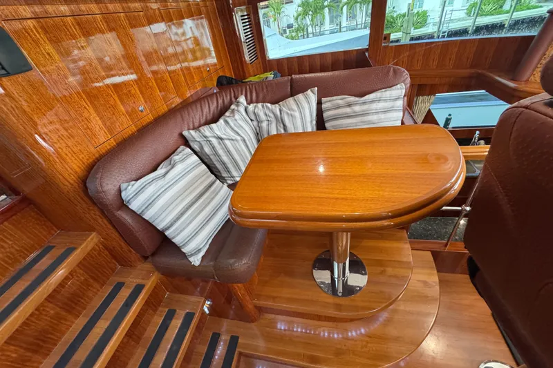 Aleniel Yacht Photos Pics Luxurious interior of 2005 Johnson 87' Motor Yacht with wood finish and cozy seating area.