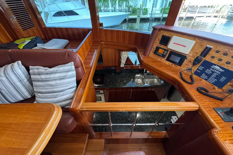 Aleniel Yacht Photos Pics Luxurious interior of a 2005 Johnson 87' Motor Yacht with wood finishes and modern controls.