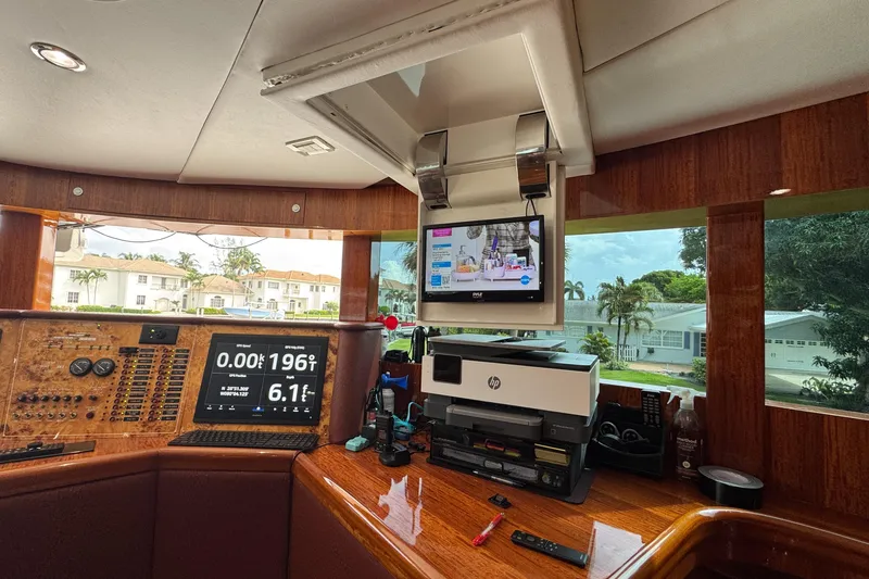 Aleniel Yacht Photos Pics Luxurious 2005 Johnson 87' Motor Yacht helm with modern navigation and entertainment systems.