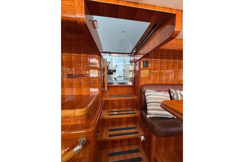 Aleniel Yacht Photos Pics Luxurious wooden interior of a 2005 Johnson 87' Motor Yacht with stairs and seating area.