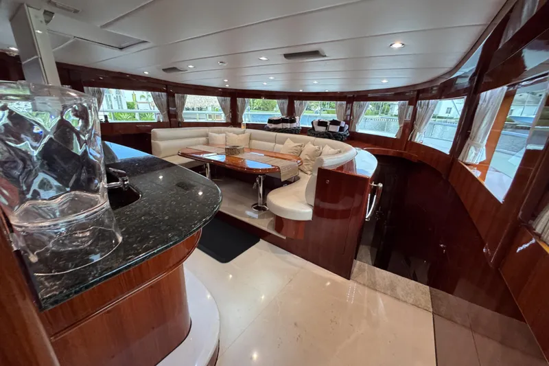 Aleniel Yacht Photos Pics Luxurious interior of 2005 Johnson 87' Motor Yacht with elegant seating and polished wood finishes.