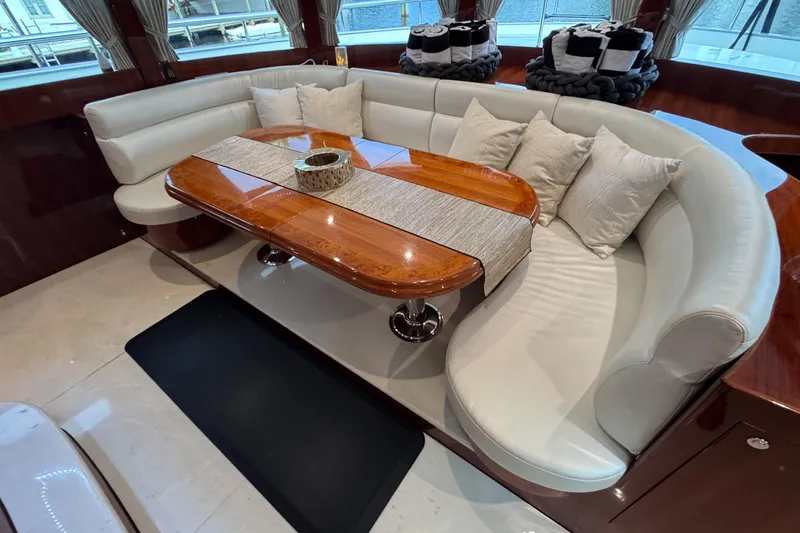Aleniel Yacht Photos Pics Luxurious interior of a 2005 Johnson 87' Motor Yacht with elegant seating and table.