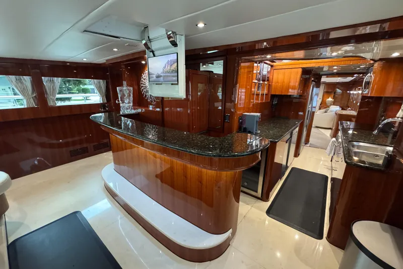 Aleniel Yacht Photos Pics Luxurious interior of a 2005 Johnson 87' Motor Yacht with elegant wood finishes and modern amenities.