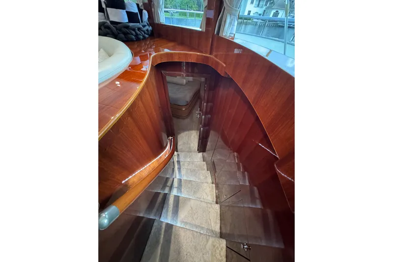 Aleniel Yacht Photos Pics Staircase inside 2005 Johnson 87' Motor Yacht with polished wood finish.