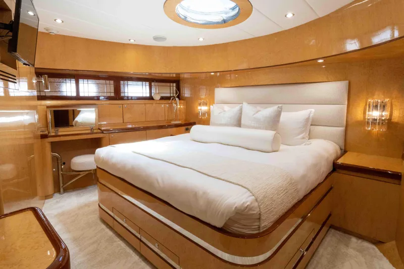 Aleniel Yacht Photos Pics Luxurious bedroom interior of 2005 Johnson 87' Motor Yacht with elegant wood finishes.
