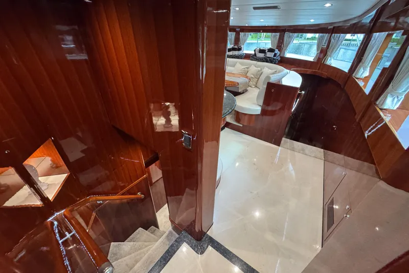 Aleniel Yacht Photos Pics Luxurious interior of 2005 Johnson 87' Motor Yacht with polished wood and elegant seating.