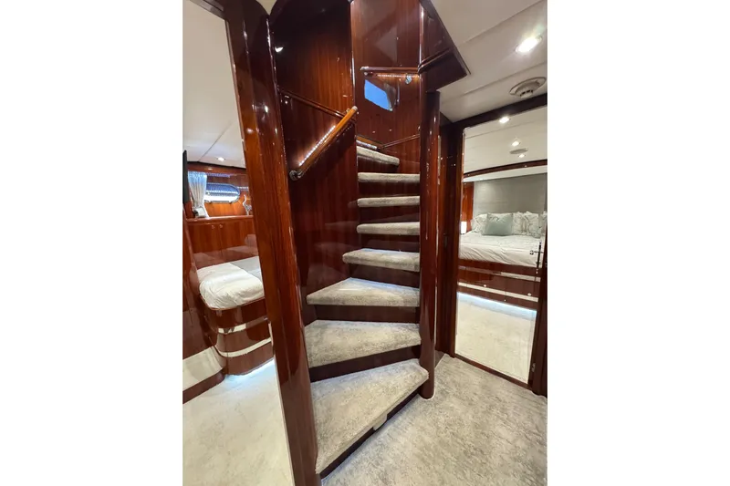 Aleniel Yacht Photos Pics Luxurious interior of 2005 Johnson 87' Motor Yacht with elegant staircase and cozy bedroom.