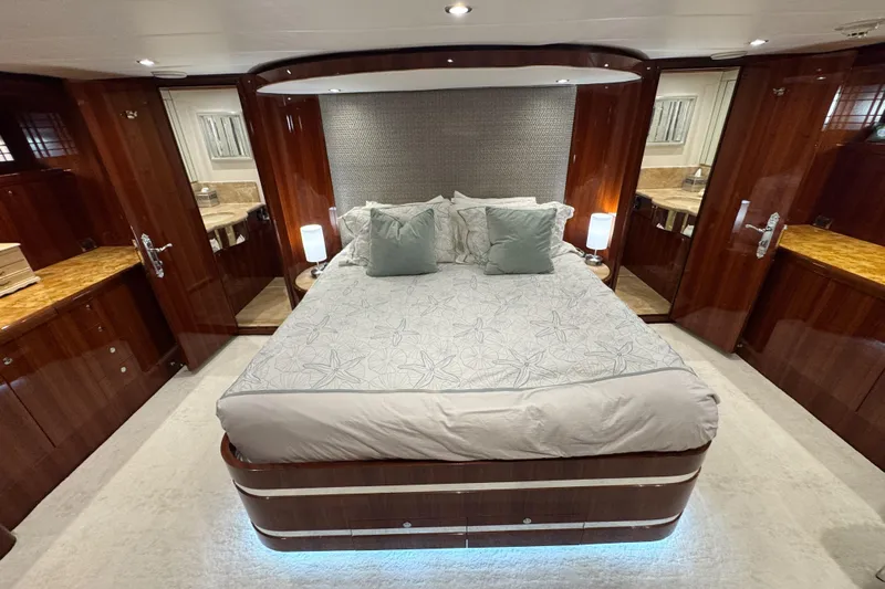 Aleniel Yacht Photos Pics Luxurious bedroom interior of 2005 Johnson 87' Motor Yacht with elegant wood finishes.