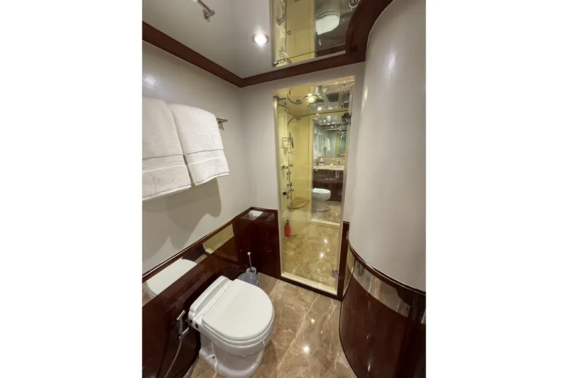Aleniel Yacht Photos Pics Luxurious bathroom on 2005 Johnson 87' Motor Yacht with elegant fixtures and marble flooring.