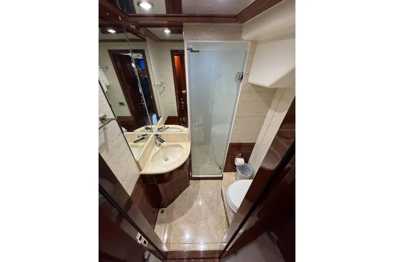 Aleniel Yacht Photos Pics Luxurious bathroom in 2005 Johnson 87' Motor Yacht with elegant fixtures and glass shower.
