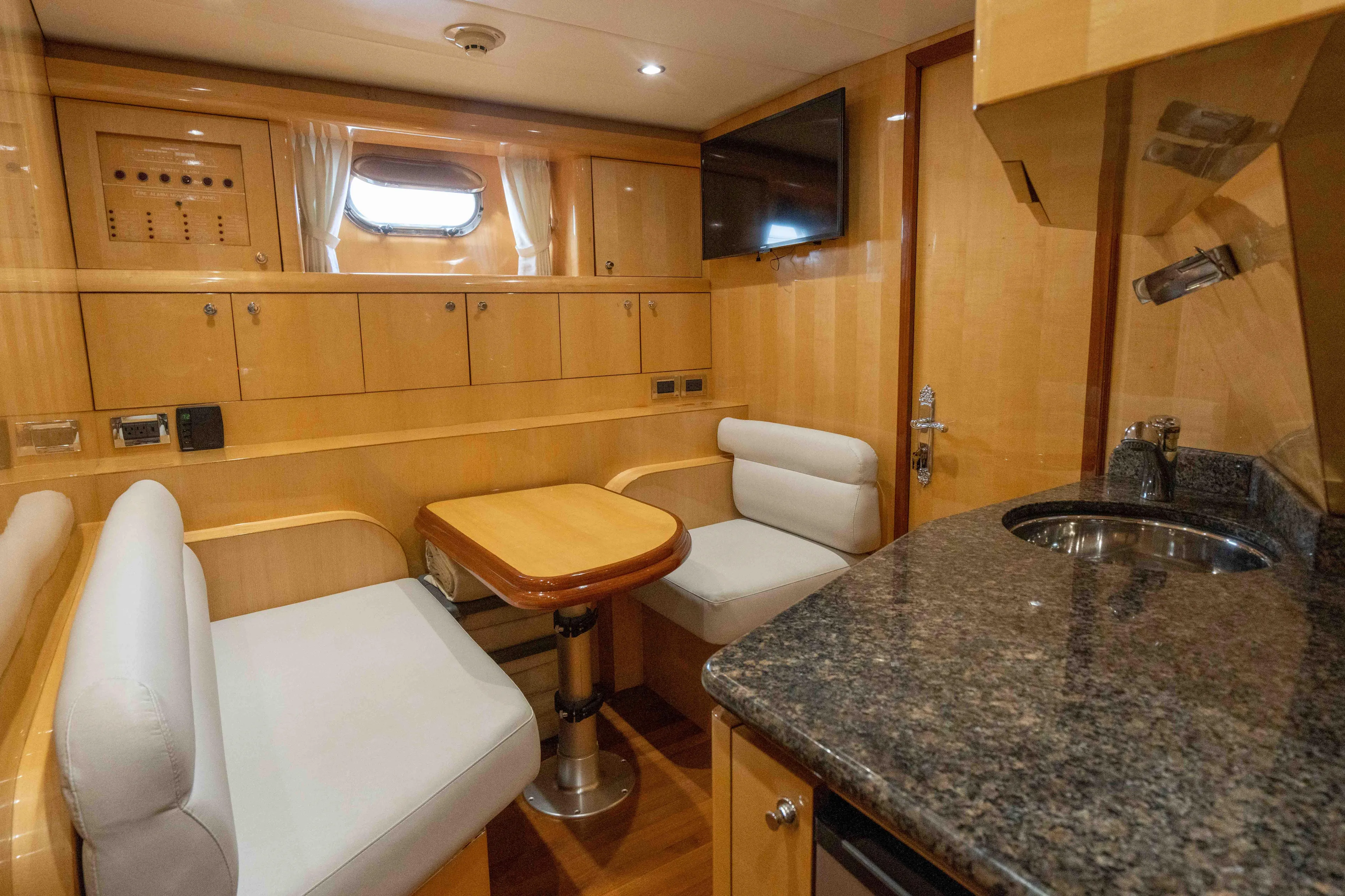 Aleniel Yacht Photos Pics Luxurious interior of 2005 Johnson 87' Motor Yacht with seating and kitchenette.