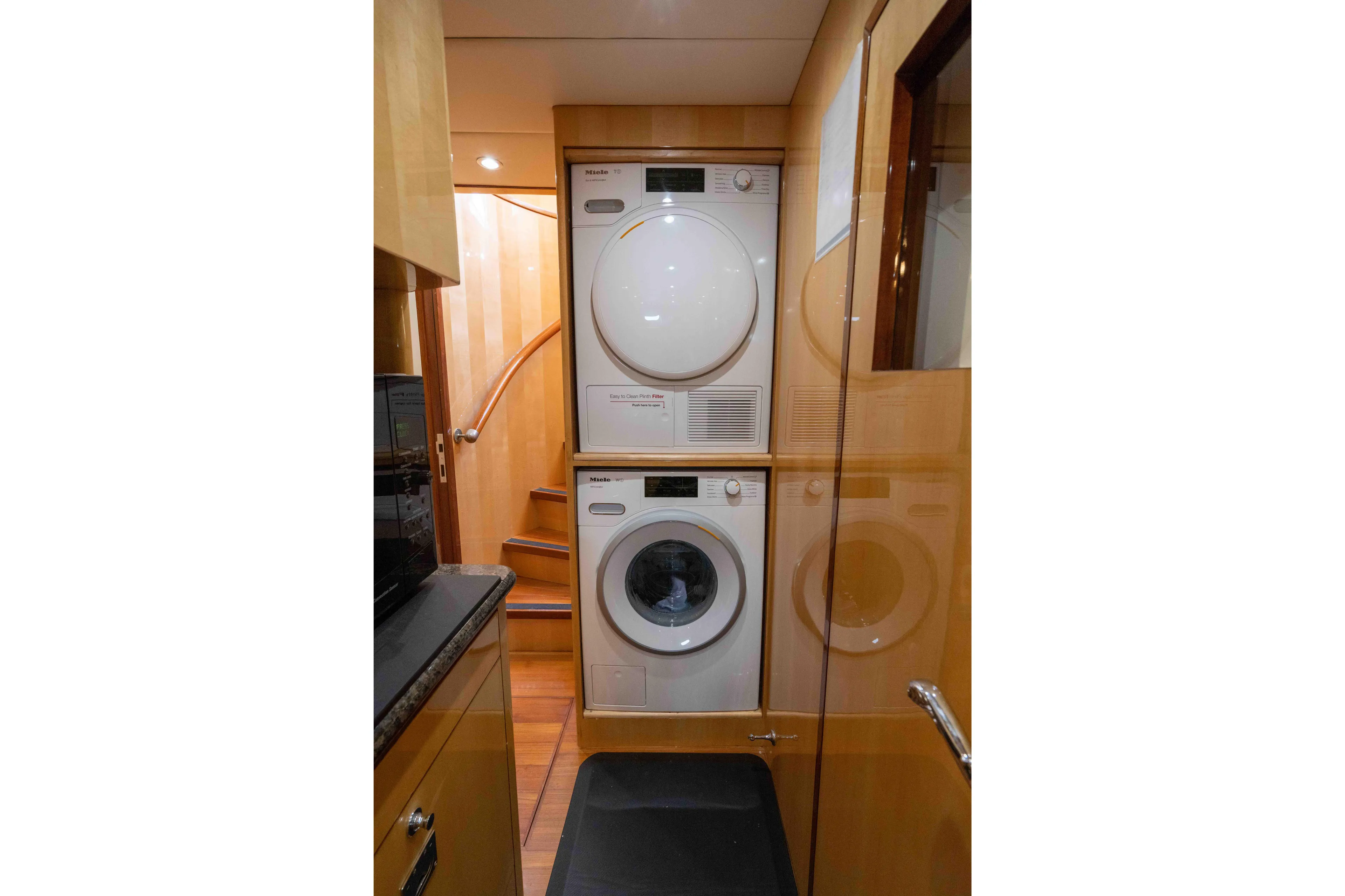 Aleniel Yacht Photos Pics Laundry area with stacked washer and dryer on 2005 Johnson 87' Motor Yacht.