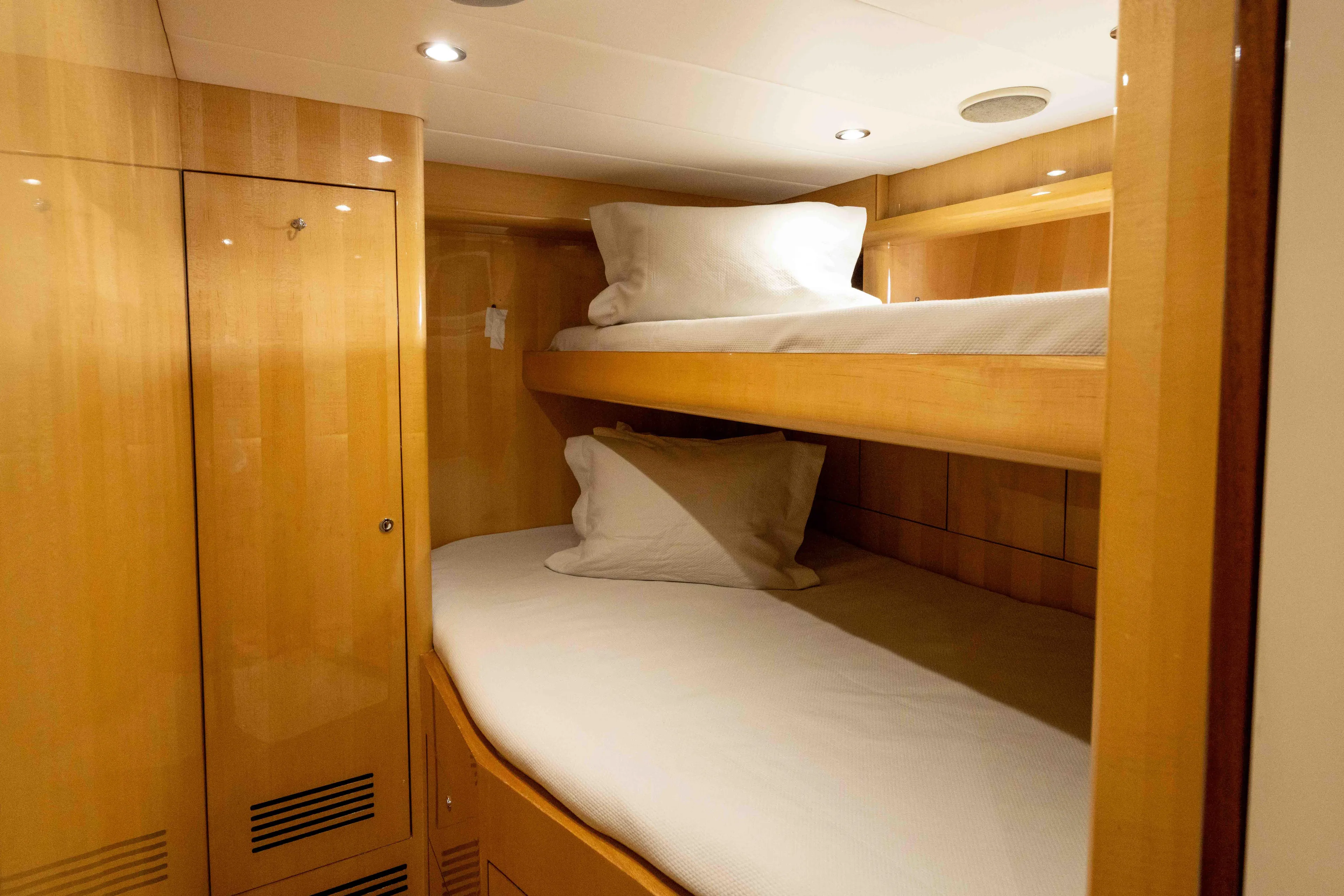 Aleniel Yacht Photos Pics Bunk beds in 2005 Johnson 87' Motor Yacht cabin with wooden interior.