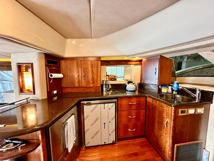 Hippeace Yacht Photos Pics Luxurious kitchen interior of 2009 Silverton Ovation 52 yacht with wood cabinetry and modern appliances.