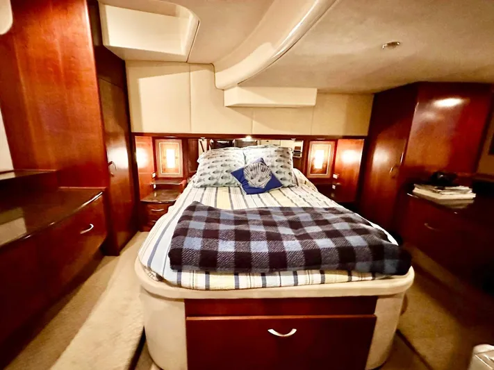 Hippeace Yacht Photos Pics Luxurious bedroom interior of 2009 Silverton Ovation 52 yacht with cozy bedding and wood finishes.